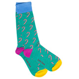 A pair of bamboo socks with a candy cane pattern on a green background, featuring blue, pink, and yellow color accents.